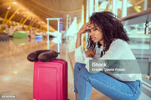 Black Woman Upset And Frustrated At The Airport With Flight Canceled Stock Photo - Download Image Now