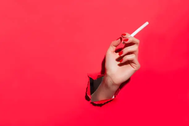 Photo of Crop female hand with cigarette