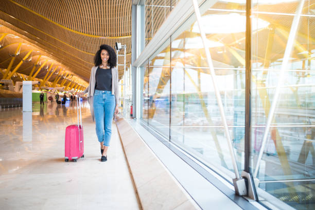 istock woman front walking at the airport 821836742