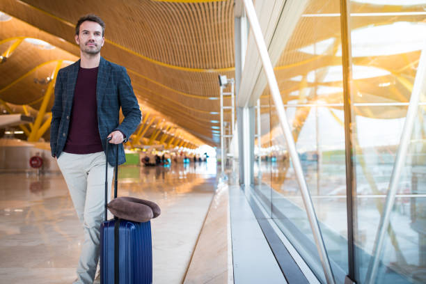 istock man front walking at the airport using mobile phone 821836864