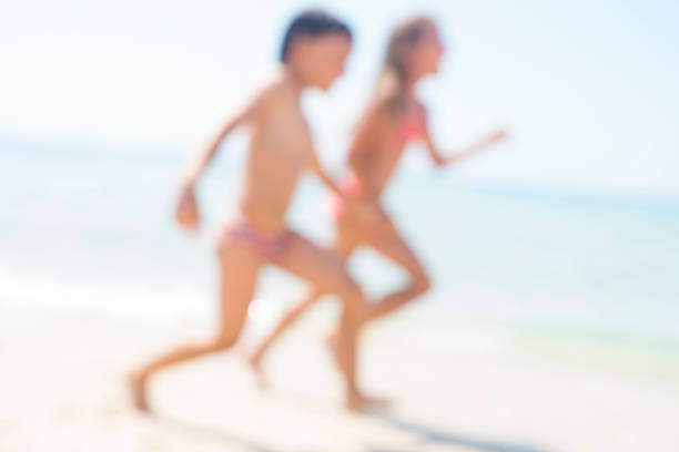 Little boy and girl playing at the beach