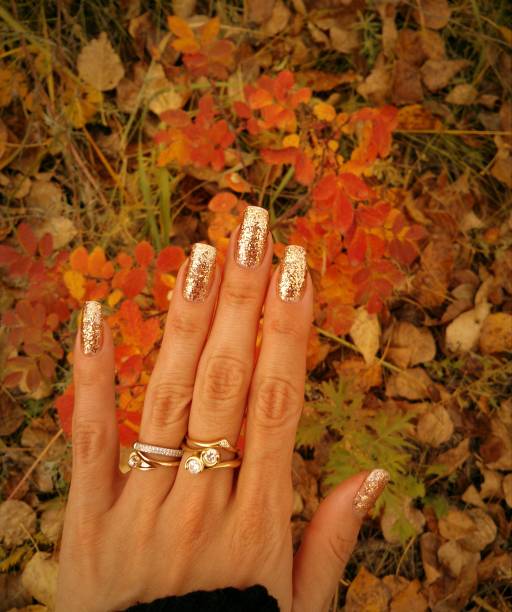 istock Autumn golden manicure. Gold glitter nails. 821840892