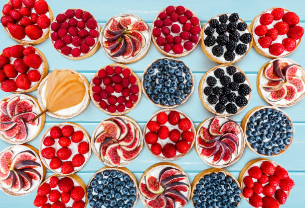 istock Fruit and Berry tarts dessert assorted top view background 821842676