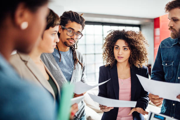 istock Female entrepreneur with her startup team reading a contract 821848830
