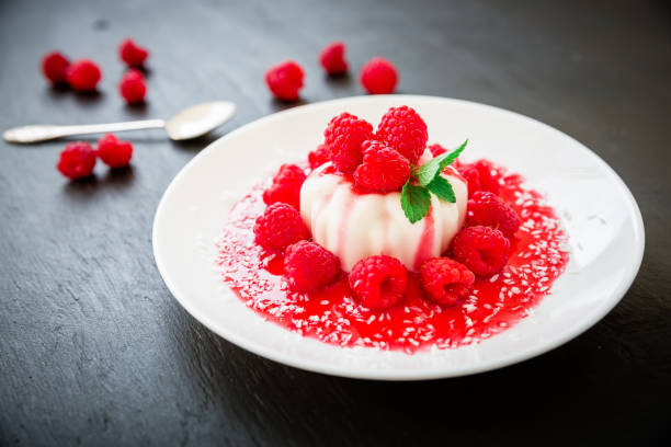 istock Delicious Panna cotta in a plate and raspberries 821856182