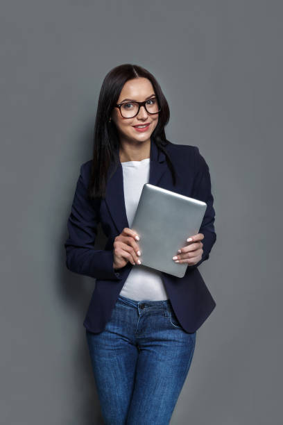 istock Woman with tablet on gray background 821859860