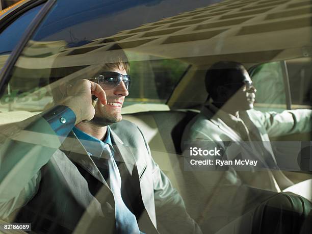 2 Men In Taxi One On Cell Phone Stock Photo - Download Image Now - 30-34 Years, Adults Only, Arizona