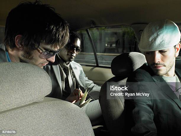 Men Paying A Taxi Driver Stock Photo - Download Image Now - Taxi Driver, 20-24 Years, 30-34 Years