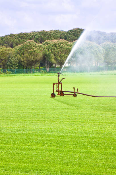 istock Metal irrigator in a green mowed lawn 821864648