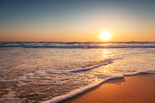 Colorful ocean beach sunrise at summer