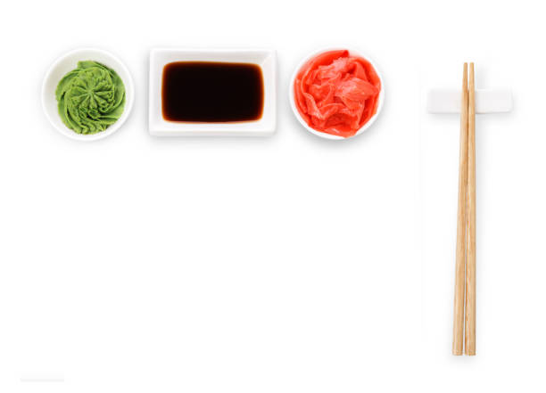 Sushi tablewear top view at white background Set of sushi tablewear. Top view on saucer with soy sauce, small white bowls for ginger and wasabi and chopsticks at white background. Flat lay, copy space soy sauce photos stock pictures, royalty-free photos & images