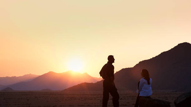 istock Silhouette Couple looking at sunset 821869290