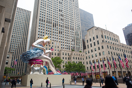 New York City, NY, May 29, 2017: Jeff Koons's inflated 'Seated Ballerina' sculpture in Rockefeller Plaza in New York City on a bright, cloudy day.