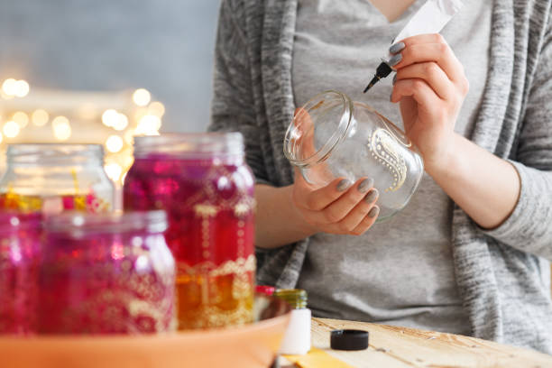 istock Woman decorating jars 821872280