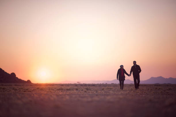 istock Couple walking together at dawn in desert 821872400