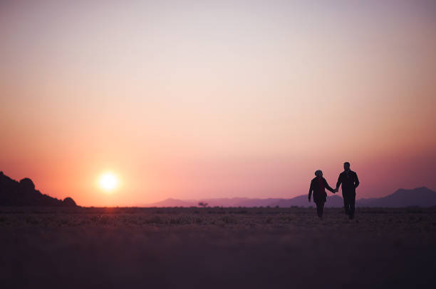istock Couple walking at dawn in desert 821872494