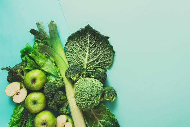 Flat lay of green vegetables on bright background