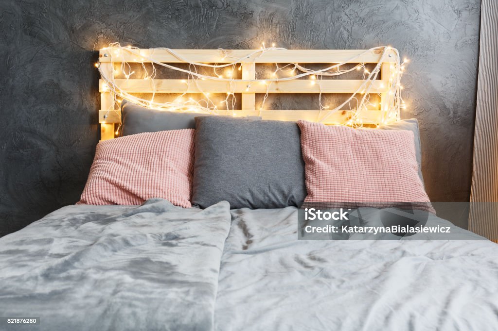 Bed with headboard Cozy dreamy bed with decorated DIY pallet headboard Headboard Stock Photo