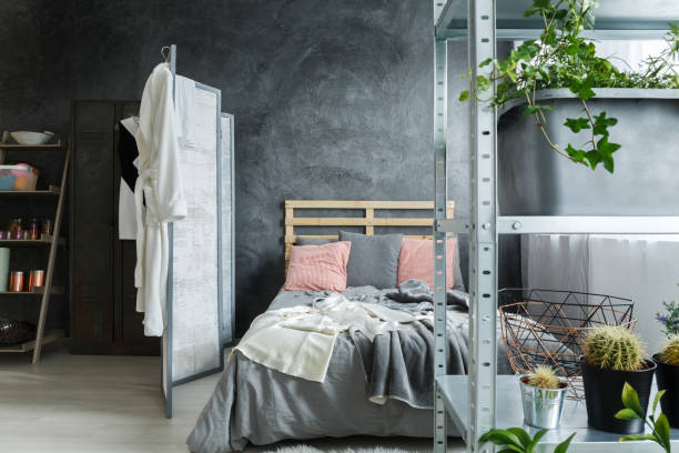 Bedroom in loft Cozy contemporary bedroom in fancy industrial loft eclectus parrot stock pictures, royalty-free photos & images