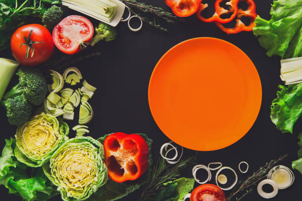 istock Frame of fresh vegetables on wooden background with copy space 821876310