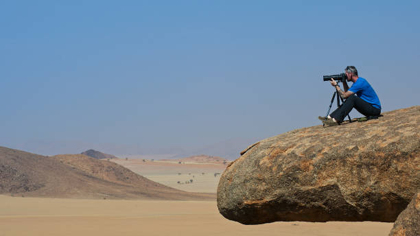 istock Man photographing in desert close up 821876504