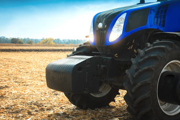 istock Modern tractor working in a field close-up. 821878050