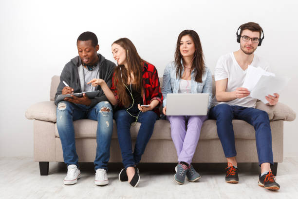 istock Young diverse people listen to music with gadgets 821880464