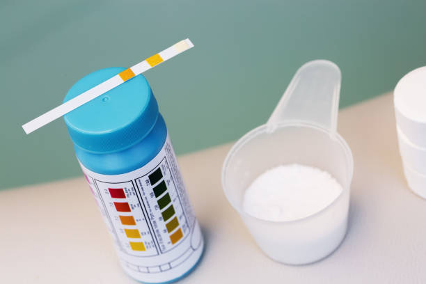 tester with tablet and powder of chlorine or bromide for mainteance of water quality of hot tub or spa stock photo