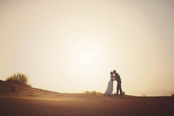 istock Married Couple Kissing in Desert 821881104