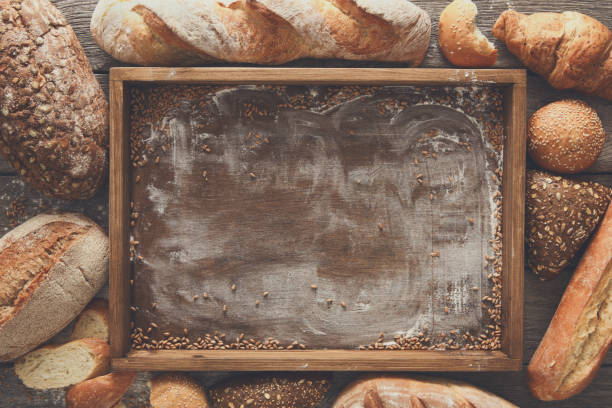 istock Bread bakery background. Brown and white wheat grain loaves comp 821887786