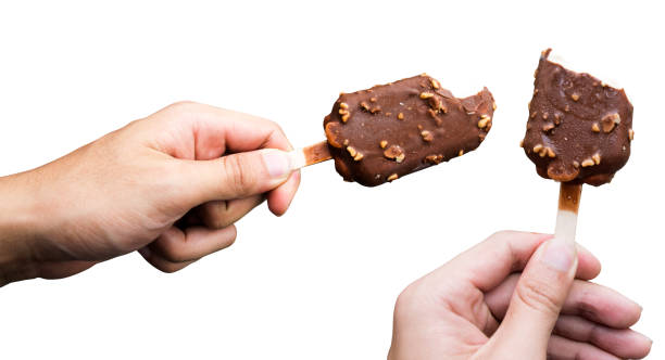 istock hand holding Chocolate almonds Ice cream bite bar isolate on white background 821889070