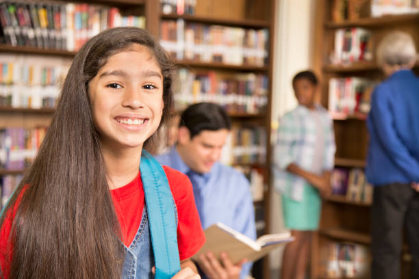istock Latin descent girl in school library. 821891890