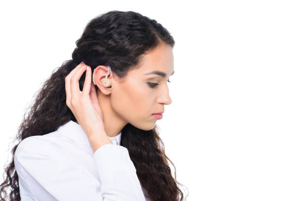 istock attractive brunette woman with hearing aid, isolated on white 821899950