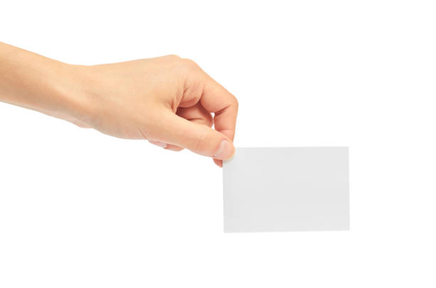 istock Female hands hold a business card. Isolated on white background 821900300