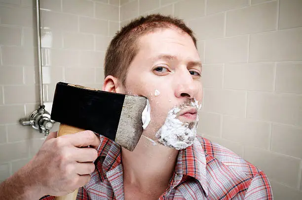Photo of man shaving with axe