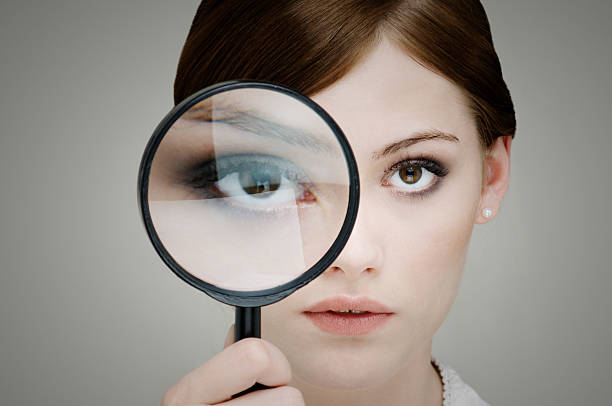 girl with magnifying glass - huge eyes imagens e fotografias de stock
