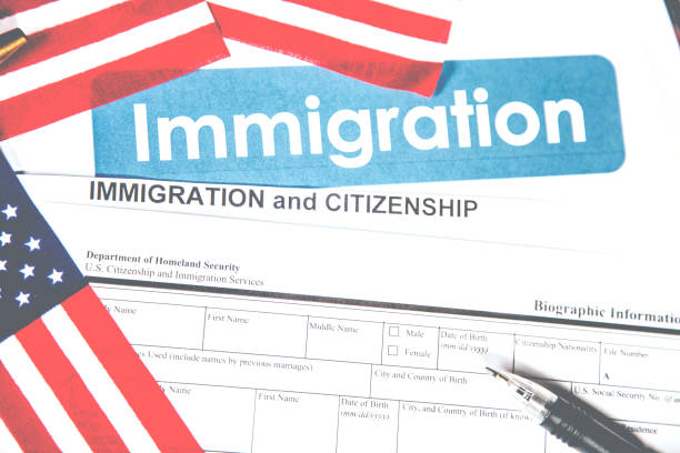 istock American immigration, citizenship forms with USA flag. 821902756