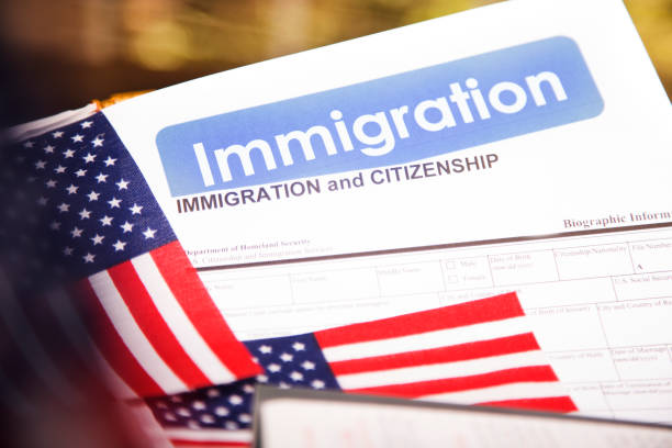 istock American immigration, citizenship forms with USA flag. 821903290