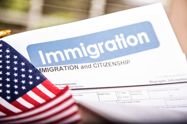 istock American immigration, citizenship forms with USA flag. 821903408