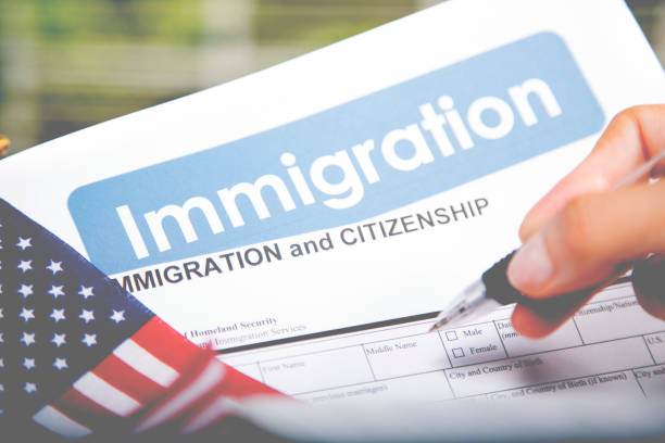 istock Person filling out American immigration, citizenship forms. USA flag. 821903708