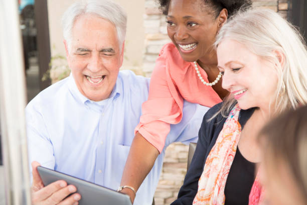 istock Multi-ethnic group of senior adult friends using digital tablet at cafe. 821910108