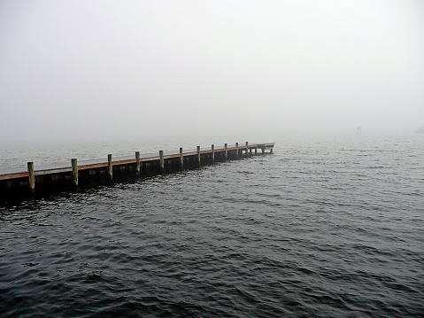 A deserted pier along the Gulf Coast shrouded in fog