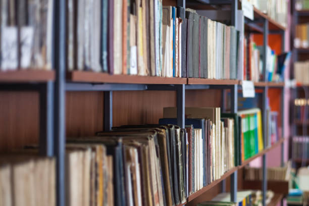 istock Bookshelf in library with many old books 821918726