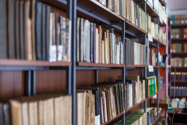 istock Bookshelf in library with many old books 821918926