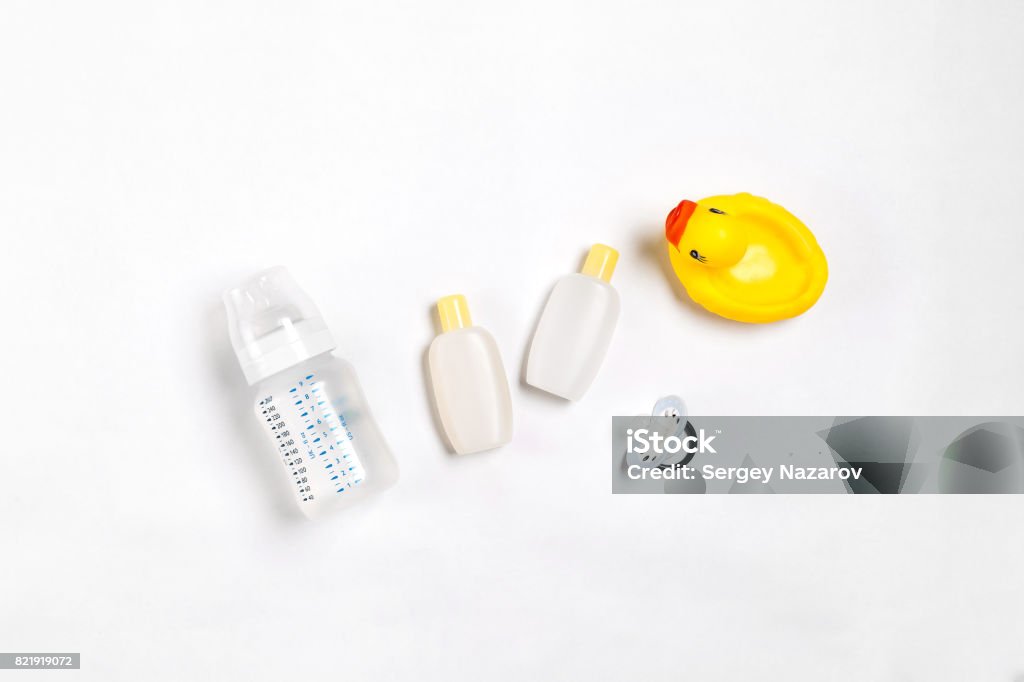 Baby accessories for bath with duck on white background. Top view Baby accessories for bath with duck on white background. Top view. Copy space. Still life. Flat lay Baby - Human Age Stock Photo