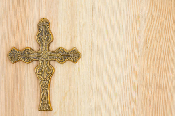 istock Cross on wood background 821919856