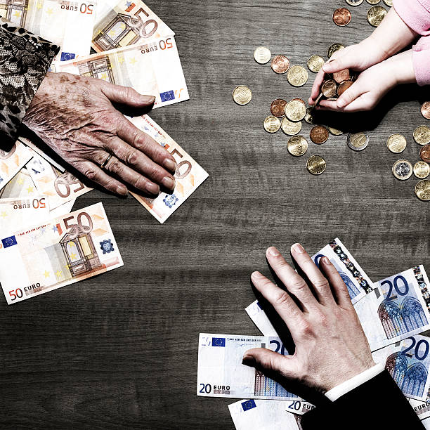 3 people's hands with money on table 3 generations of hands with euro coins and notes on table netherlands currency stock pictures, royalty-free photos & images