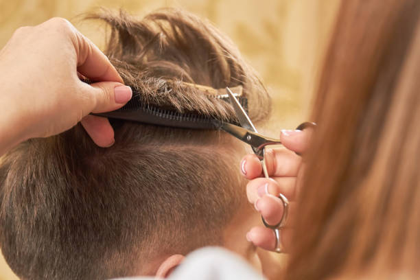 istock Hands of barber, scissors and comb. 821922948