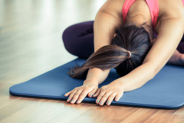 istock Woman practicing yoga pose in gym 821924064