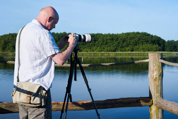 istock Photographer on a lake 821924212